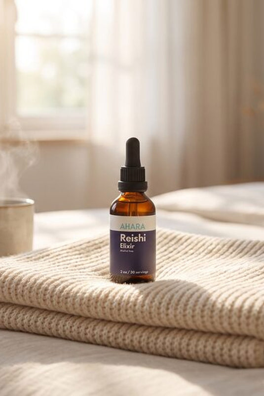 AHARA Reishi Elixir, an alcohol-free liquid reishi extract, on a bed