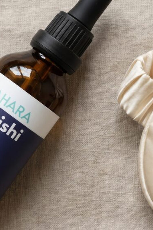 The Reishi Elixir resting beside a soft sleep mask and dried lavender